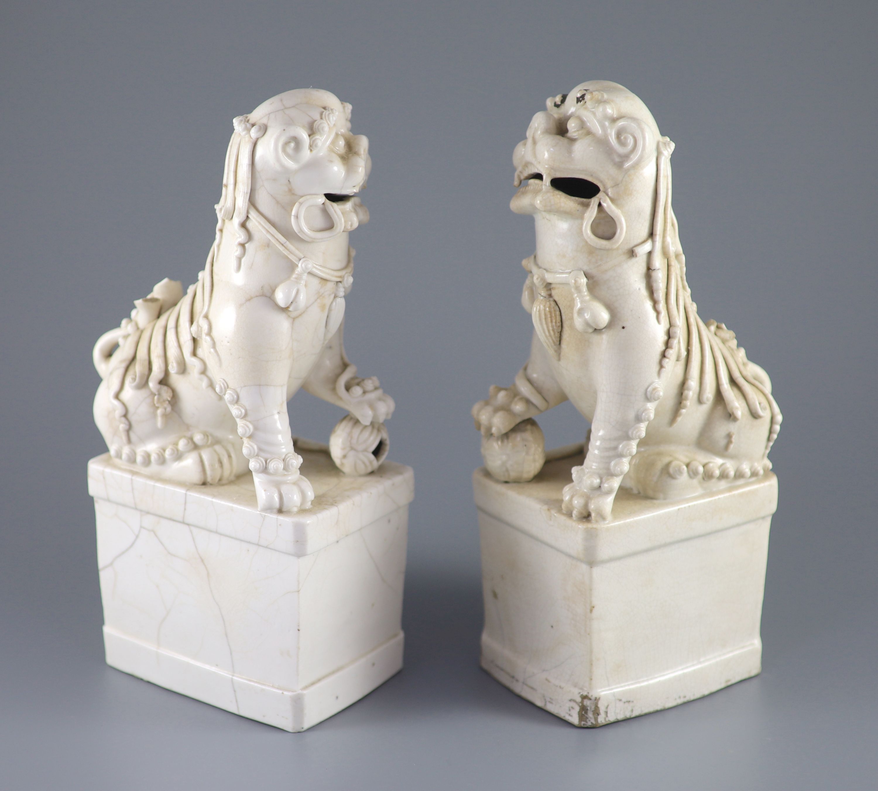 A pair of Chinese Dehua Blanc de chine kylin joss stick holders, some cracks. 26cms
